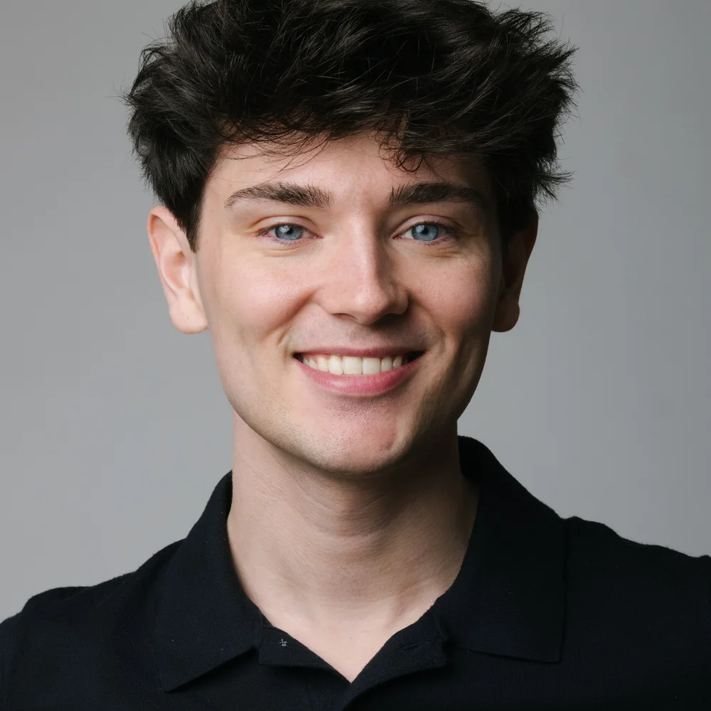 headshot-young-man-curly-hair-black-polo-nyc-headshots.jpg
