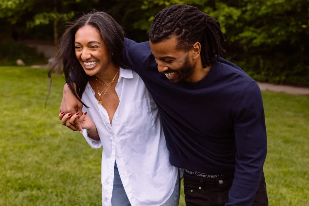 engagement-couple-walking-laughing-grass.jpg