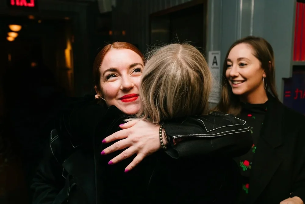 Guests greeting each other with a hug at the Trinny London VIP dinner, NYC event photographer
