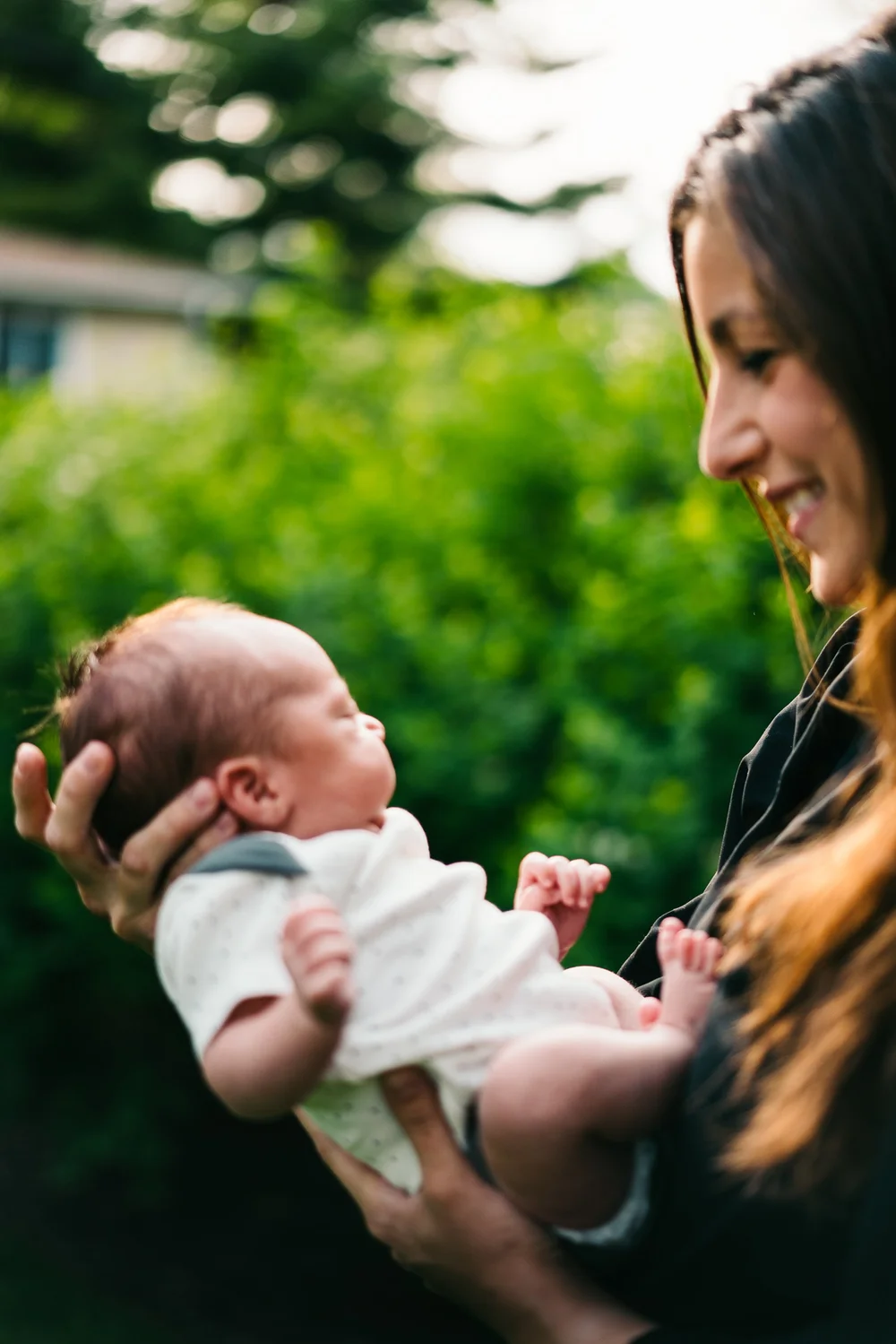 mother-holding-newborn-outdoors.jpg