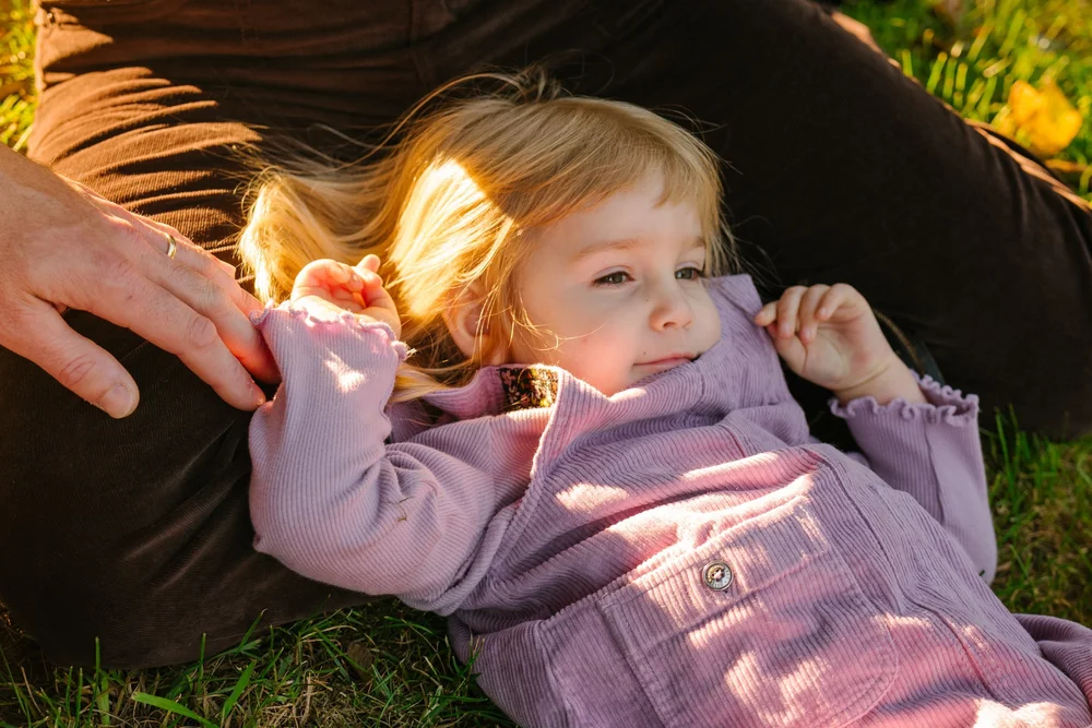 toddler-lying-picnic-blanket-smiling.jpg
