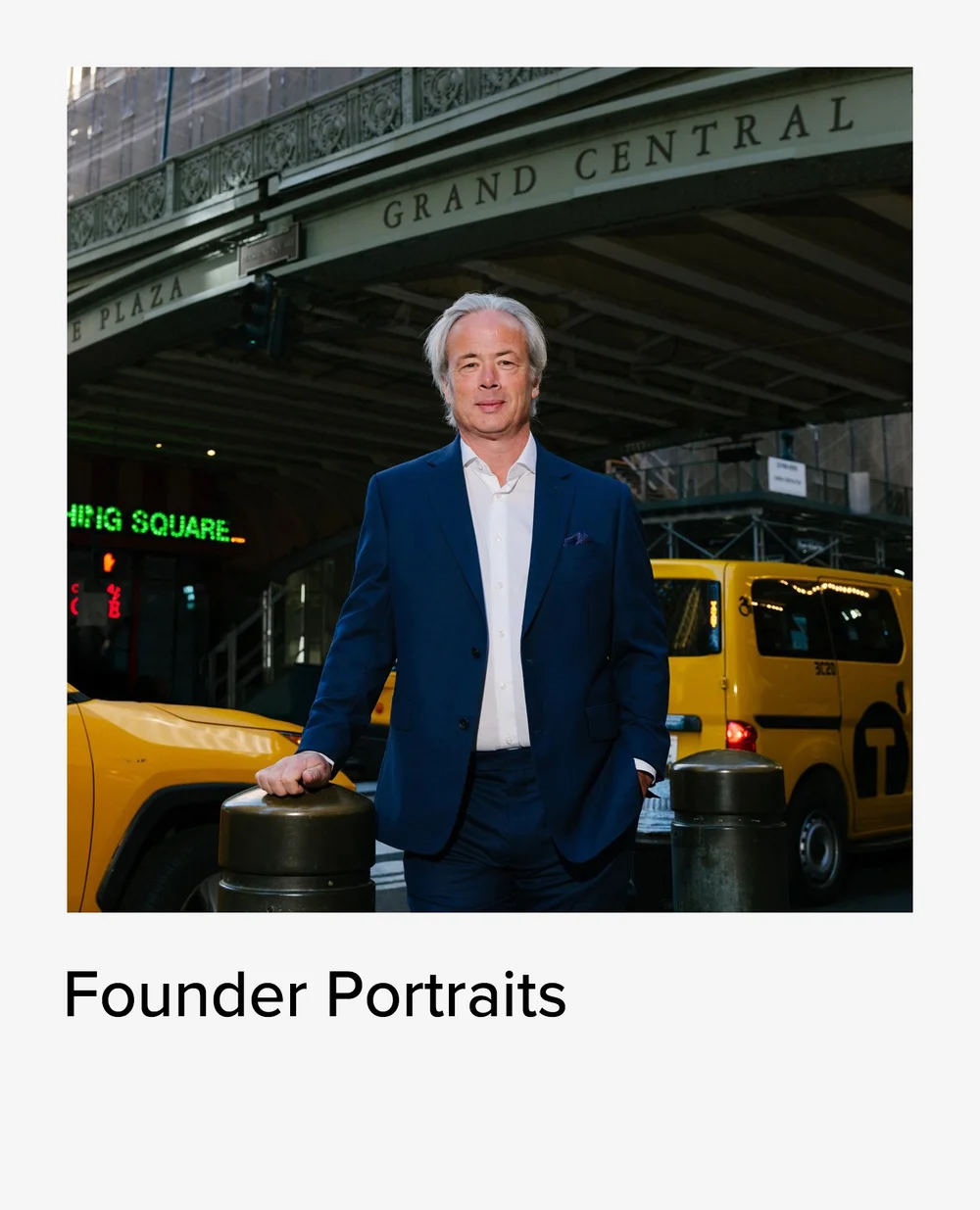 Founder portrait of a man in a navy suit beside a yellow taxi near Grand Central
