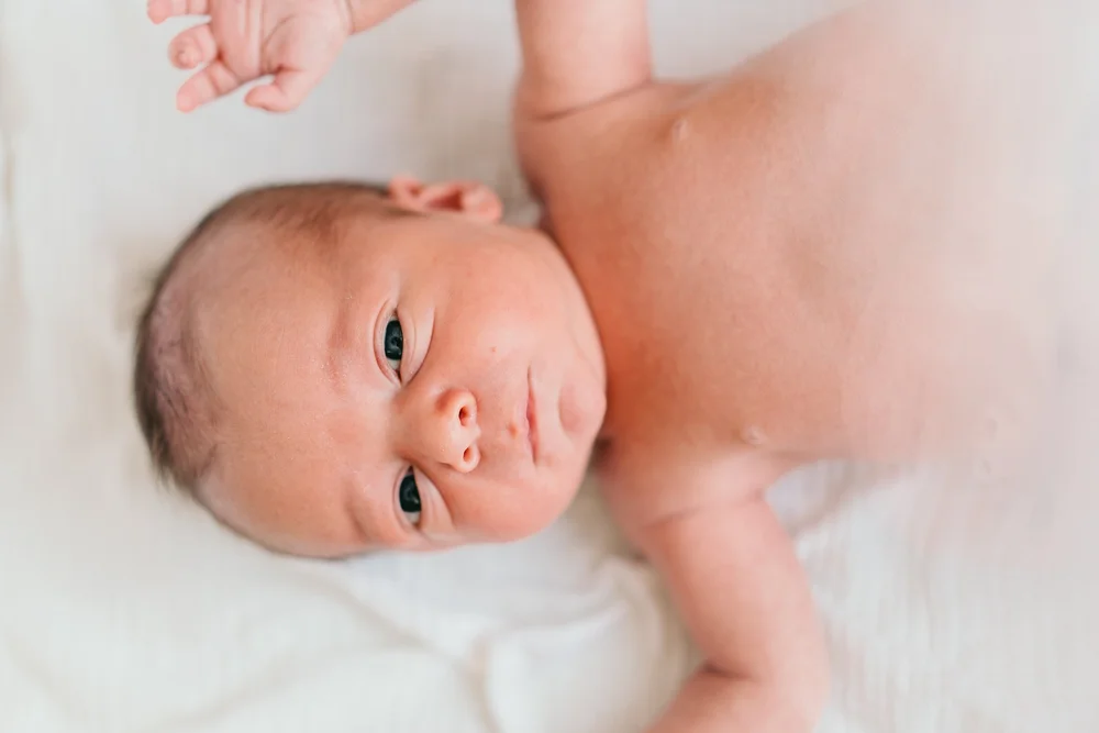 newborn-white-blanket-looking-up.jpg