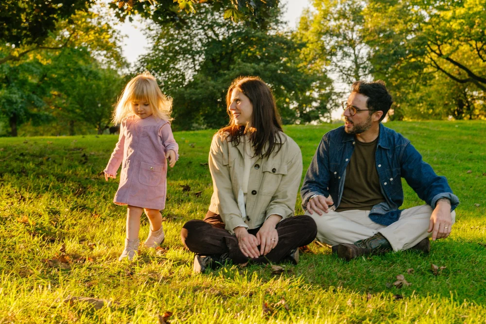 family-sitting-grass-golden-light.jpg