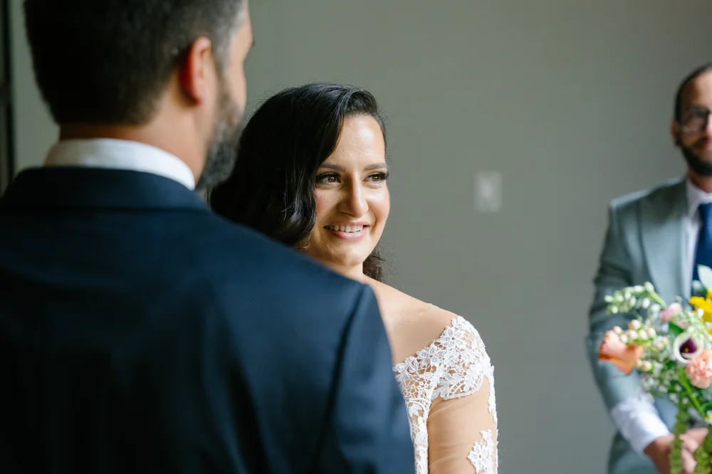 bride-smiling-at-groom-wedding-ceremony.jpg