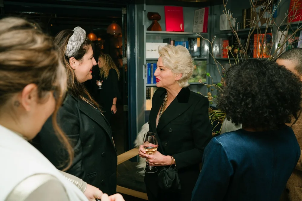trinny-london-vip-dinner-guests-conversation-bookshelves.jpg