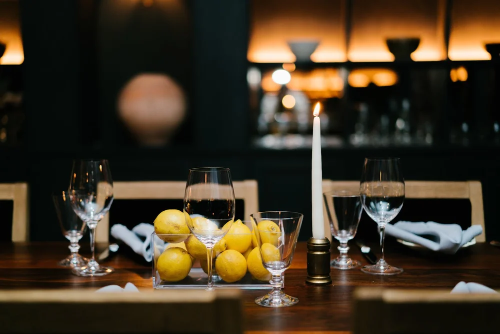 Candlelit table set with lemons at the Trinny London VIP dinner in NYC